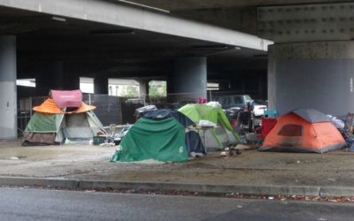 How can I help the homeless I see along highway intersections?